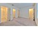 Spacious bedroom with dual closets, carpeting, and neutral tones, offering ample storage and comfort at 2882 Peony Prairie Ln, Wesley Chapel, FL 33543