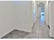 Bright hallway with tile flooring and neutral paint, leading to the main living area at 2882 Peony Prairie Ln, Wesley Chapel, FL 33543