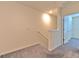 Upstairs hallway featuring plush carpeting and neutral paint, leading to the bedrooms and other living areas at 2882 Peony Prairie Ln, Wesley Chapel, FL 33543
