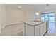 Kitchen island featuring granite countertops, stainless steel appliances, and white cabinetry at 2882 Peony Prairie Ln, Wesley Chapel, FL 33543