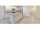 Bright kitchen with white cabinetry, granite countertops, and stainless steel appliances at 2882 Peony Prairie Ln, Wesley Chapel, FL 33543