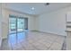Bright and airy living room with tile flooring and sliding glass doors to the patio at 2882 Peony Prairie Ln, Wesley Chapel, FL 33543