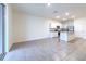 Spacious living room showcases an open layout to the modern kitchen, ideal for entertaining and comfortable everyday living at 2882 Peony Prairie Ln, Wesley Chapel, FL 33543