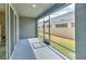 Enclosed patio with a view to the fenced-in backyard and neighboring homes at 2882 Peony Prairie Ln, Wesley Chapel, FL 33543