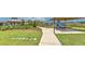 Community playground with slides and picnic tables surrounded by lush green grass and walking path at 2882 Peony Prairie Ln, Wesley Chapel, FL 33543
