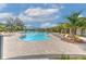 This inviting community pool features abundant seating, shade structures, and lush landscaping at 2882 Peony Prairie Ln, Wesley Chapel, FL 33543