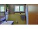 Well-lit bathroom featuring butterfly artwork, vanity with sink and a tiled wall at 307 Druid Hills Rd, Temple Terrace, FL 33617