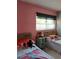 bedroom with two twin beds, vintage bedside table, and colorful decor at 307 Druid Hills Rd, Temple Terrace, FL 33617