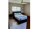 Bedroom featuring a comfortable bed, side tables with lamps and a ceiling fan at 307 Druid Hills Rd, Temple Terrace, FL 33617