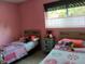 bedroom with two twin beds, vintage bedside table, and colorful decor at 307 Druid Hills Rd, Temple Terrace, FL 33617