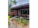Inviting front porch with a bench, modern front door, and well-manicured landscaping at 307 Druid Hills Rd, Temple Terrace, FL 33617