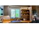 Bright kitchen featuring open shelving, a garden window, and stainless steel appliances at 307 Druid Hills Rd, Temple Terrace, FL 33617
