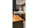 Well-appointed kitchen featuring wood cabinets, butcher block countertops, and modern appliances at 307 Druid Hills Rd, Temple Terrace, FL 33617