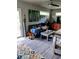 Comfortable living room featuring a leather sofa, wood-look floors and an eclectic collection of decor at 307 Druid Hills Rd, Temple Terrace, FL 33617