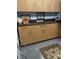 Storage room with wood cabinets, large countertop, tile floors, and natural light at 307 Druid Hills Rd, Temple Terrace, FL 33617