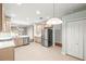 Bright kitchen with stainless steel appliances, tile flooring, and adjacent dining area at 30901 Prout Ct, Wesley Chapel, FL 33543