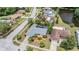 Aerial view of home and neighborhood featuring a pool, mature trees, and landscaped yards at 3230 Player Dr, New Port Richey, FL 34655