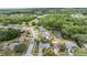 Community view featuring mature trees, ponds, landscaping, and nearby streets at 3230 Player Dr, New Port Richey, FL 34655