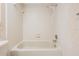 Close up view of bathtub and shower in bathroom with tiled walls and silver hardware at 3230 Player Dr, New Port Richey, FL 34655