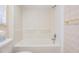 Bathroom features a clean tub and toilet, with neutral-toned walls and tiling at 3230 Player Dr, New Port Richey, FL 34655