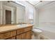 Traditional bathroom featuring a single sink vanity and a shower-tub combo with neutral finishes at 3230 Player Dr, New Port Richey, FL 34655