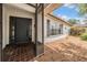 Inviting home entrance featuring a screen door, dark front door, and adjacent window with shutters at 3230 Player Dr, New Port Richey, FL 34655