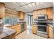 Bright kitchen boasts stainless appliances, wood cabinets, and a sunny window at 3230 Player Dr, New Port Richey, FL 34655