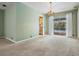 Expansive living room with neutral carpet and view to the outdoor pool through sliding glass doors at 3230 Player Dr, New Port Richey, FL 34655