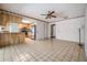 Open-concept living space with tile flooring adjacent to the bright kitchen at 3230 Player Dr, New Port Richey, FL 34655