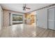 Open-concept living room area adjacent to the kitchen and overlooking a pool at 3230 Player Dr, New Port Richey, FL 34655