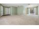 Open-concept living room with neutral carpet and multiple entryways, ideal for easy flow and entertaining at 3230 Player Dr, New Port Richey, FL 34655