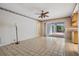 Cozy living area with tile flooring, ceiling fan, and access to outdoor patio at 3230 Player Dr, New Port Richey, FL 34655