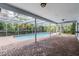 Screened in pool and patio area with brick pavers, offering a serene outdoor living space at 3230 Player Dr, New Port Richey, FL 34655