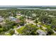 Beautiful aerial view of a neighborhood with mature trees and glimpses of a waterway in the distance at 3236 San Pedro St, Clearwater, FL 33759