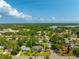 Aerial image featuring the tops of houses and trees within a community, taken on a bright day at 3236 San Pedro St, Clearwater, FL 33759