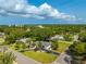 Overhead picture reveals a home with lush green lawn and trees, set against a blue sky backdrop at 3236 San Pedro St, Clearwater, FL 33759