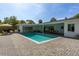 Inviting backyard with a sparkling pool, brick patio, and cozy seating for outdoor enjoyment at 3236 San Pedro St, Clearwater, FL 33759