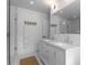 Bathroom featuring double sinks, walk-in shower, and custom patterned tile flooring at 3236 San Pedro St, Clearwater, FL 33759