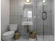 Stylish bathroom featuring patterned tile, a glass-enclosed shower, and modern fixtures at 3236 San Pedro St, Clearwater, FL 33759