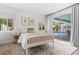 Bright bedroom with a backyard pool view through sliding glass doors at 3236 San Pedro St, Clearwater, FL 33759
