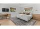 Spacious bedroom with wood floors, ceiling fan, natural light, and a comfortable seating area at 3236 San Pedro St, Clearwater, FL 33759