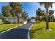 Beautiful single-story home with a well-manicured lawn, mature trees, and a curved driveway at 3236 San Pedro St, Clearwater, FL 33759