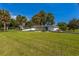 Expansive front yard with lush lawn and beautiful landscaping showcasing this modern single-story home at 3236 San Pedro St, Clearwater, FL 33759