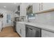 Kitchen boasts quartz countertops, white cabinets, stainless steel appliances, and a farmhouse sink at 3236 San Pedro St, Clearwater, FL 33759