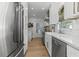 Kitchen boasts quartz countertops, white cabinets, stainless steel appliances, and a farmhouse sink at 3236 San Pedro St, Clearwater, FL 33759