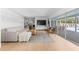 Spacious and bright living room showcasing an open floor plan, hardwood floors and pool views at 3236 San Pedro St, Clearwater, FL 33759