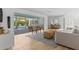 Bright living room with hardwood floors, a view of the pool, and stylish furnishings at 3236 San Pedro St, Clearwater, FL 33759