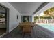Covered outdoor dining area featuring a large table and view of the sparkling swimming pool at 3236 San Pedro St, Clearwater, FL 33759