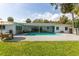 A backyard swimming pool with brick pavers, poolside seating, and a covered patio at 3236 San Pedro St, Clearwater, FL 33759