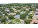 Aerial view of the neighborhood, highlighting the home, mature trees and greenery at 3727 Janus Way, Palm Harbor, FL 34685
